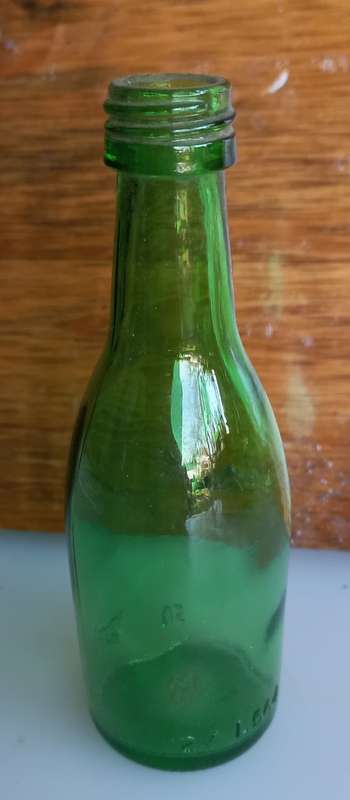 Small vintage green glass bottle