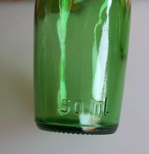 Small vintage green glass bottle