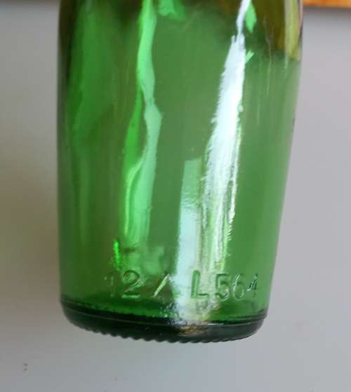 Small vintage green glass bottle