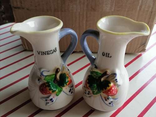 Small set containing oil and vinegar, salt and pepper and a small pot.