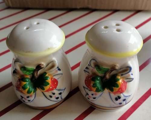 Small set containing oil and vinegar, salt and pepper and a small pot.