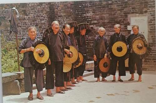 Vintage postcard: Village women outside Kathing walled city