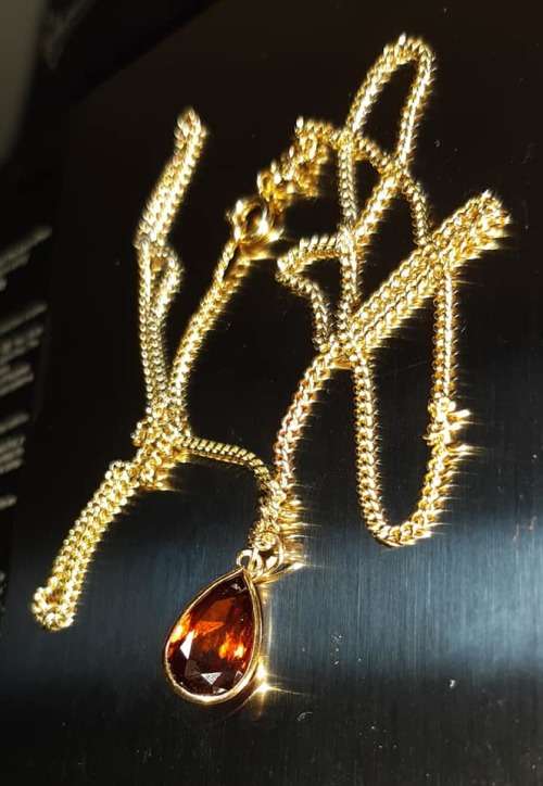 18ct yellow gold Curb Chain with 18ct Gold Pendent Set With A 14x7mm Teardrop Garnet. French made.