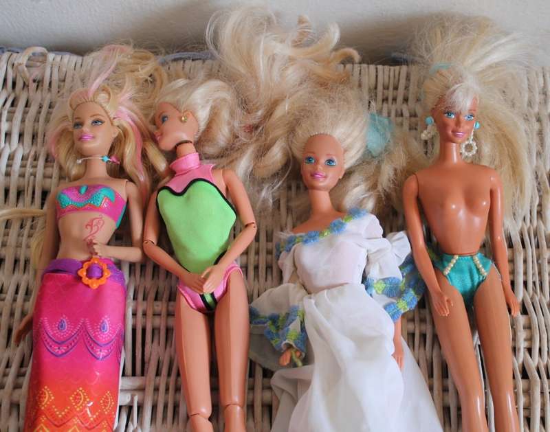 2 Ken dolls and 4 Barbies