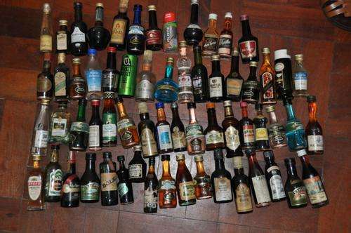 VINTAGE COLLECTION OF 62 SMALL (50ML) BOTTLES OF VARIOUS LIQUERS,ALL FULL,NEVER BEEN OPENED