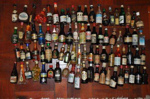 VINTAGE COLLECTION OF 81 SMALL (50ML) BOTTLES OF VARIOUS LIQUERS,ALL FULL,NEVER BEEN OPENED