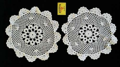 Two white crochet doilies