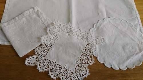 Four small white cloths/ doilies