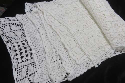 Six white crochet table mats or tray cloths