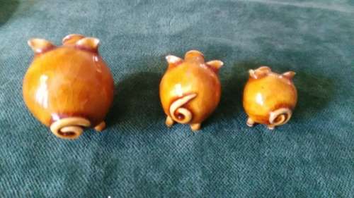 Three little pottery pigs for the printer's tray