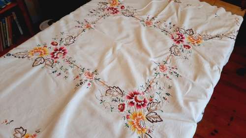 Beige cotton tablecloth heavily embroidered with colourful flowers  (120 x 120 cm)