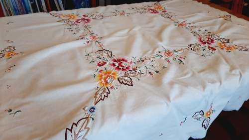 Beige cotton tablecloth heavily embroidered with colourful flowers  (120 x 120 cm)