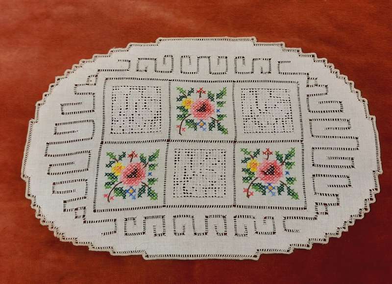 Embroidered doilie mat with cross stitch flower motifs- 29 x 18 cm