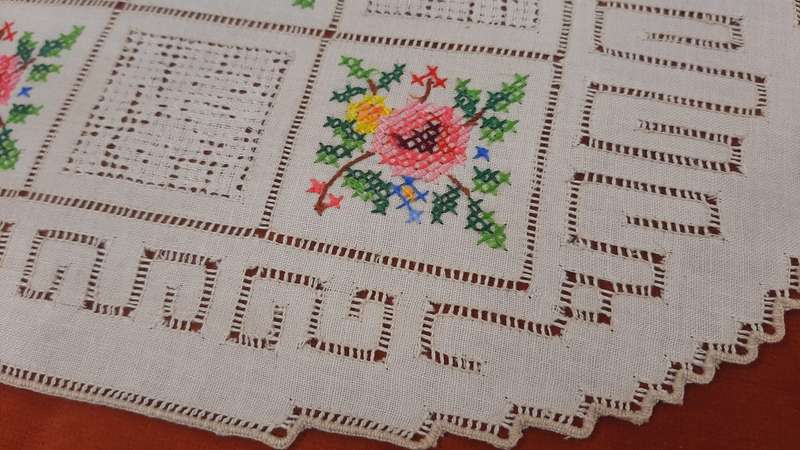Embroidered doilie mat with cross stitch flower motifs- 29 x 18 cm