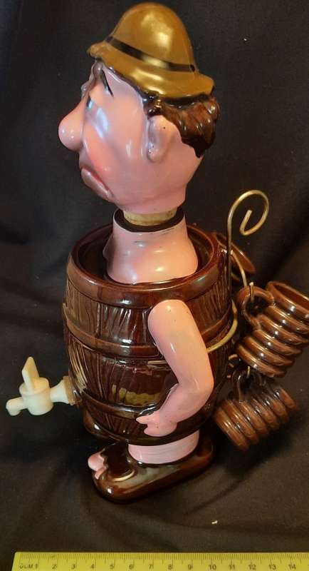 Decanter Man in Barrel with four small mugs on his Back