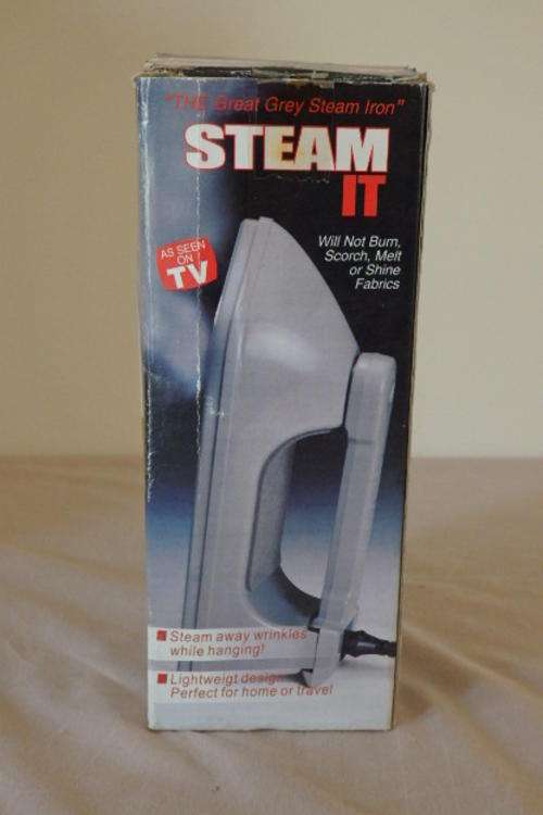 AN AWESOME TRAVEL STEAM IRON IN ITS ORIGINAL BOX WITH A MEASURING CUP & INSTRUCTIONS