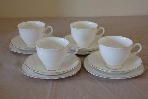 FOUR EXQUISITE COLCLOUGH (ROYAL DOULTON) "CLASSIC WHITE" PATTERN BONE CHINA TRIO'S bid/trio
