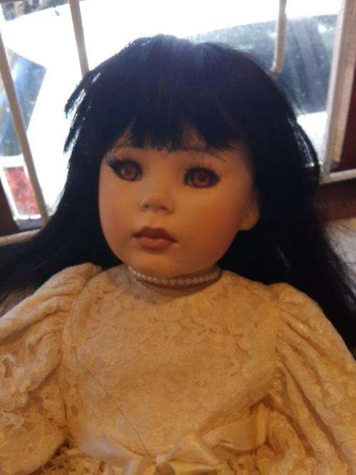 Beautiful porcelain / Bisque type doll long dark hair, brown eyes arms, legs and head move - signed