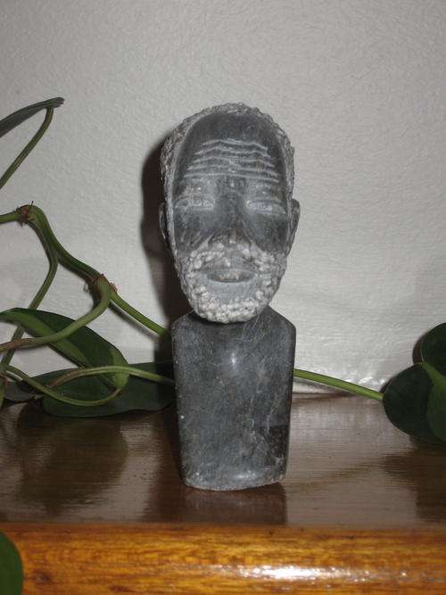 The "bust" of a Xhosa appears to be made of granite.  Carved with intricate detail