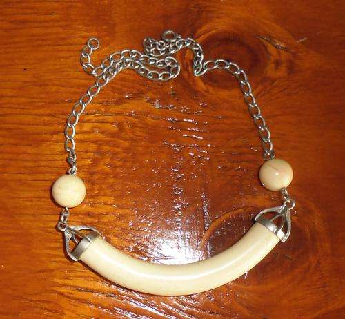 Pretty ivory (faux) necklace with silver coloured chain