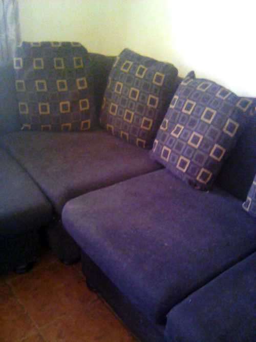 Black, L - shape, corduroy couch with cussions