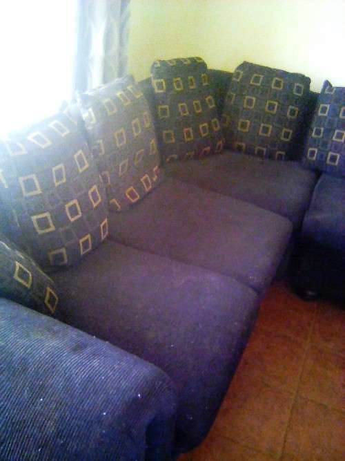Black, L - shape, corduroy couch with cussions