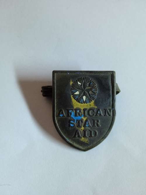 African Star Aid pin badge
