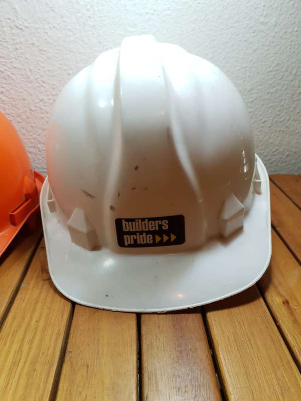 PAIR OF UNUSED BUILDERS PRIDE SAFETY HELMET.