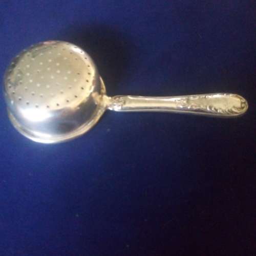 TEA STRAINER WITH HALLMARKED SILVER HANDLE