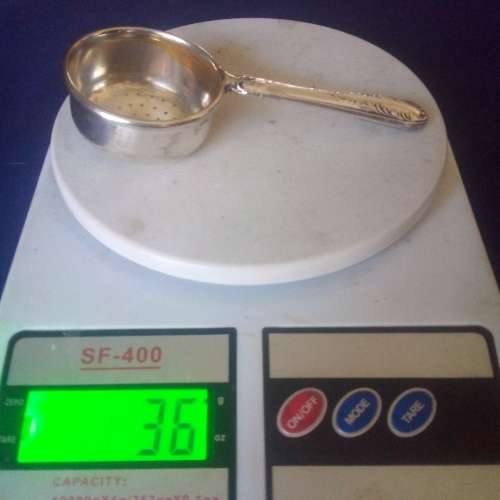 TEA STRAINER WITH HALLMARKED SILVER HANDLE