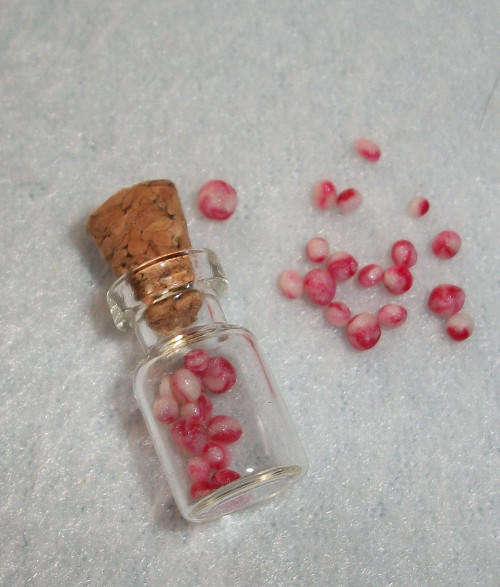 Miniature glass jar filled with bonbons.