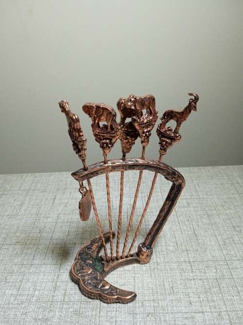 Copper olive sticks on stand