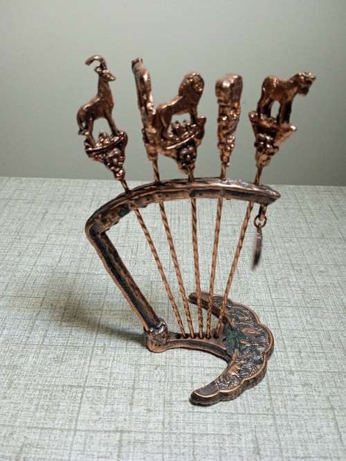 Copper olive sticks on stand