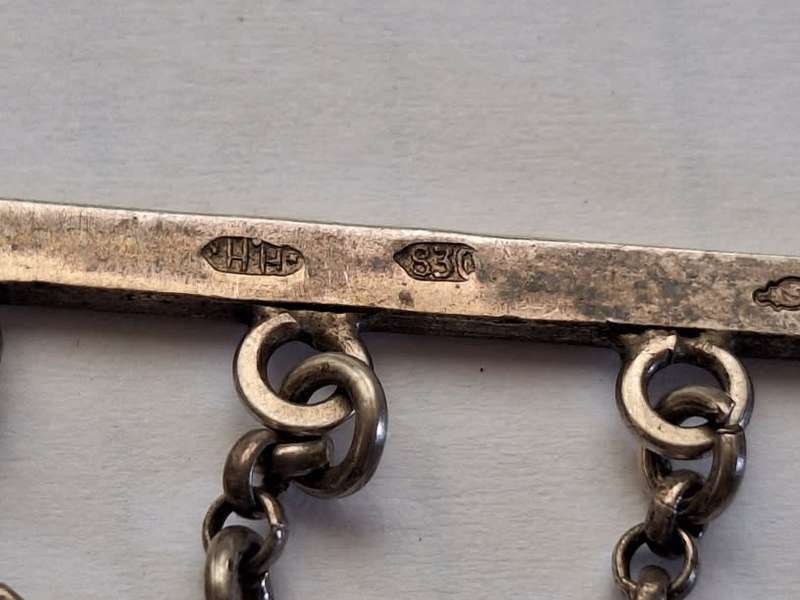 Stunning silver brooch adorned with trinkets