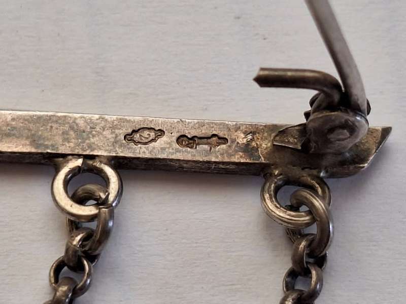 Stunning silver brooch adorned with trinkets