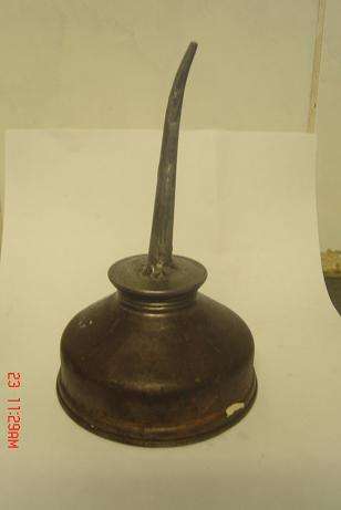 AN OLD COPPER OIL CAN