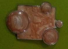 PECULIARLY SHAPED ENAMEL COATED? TAN COLOURED PENDANT