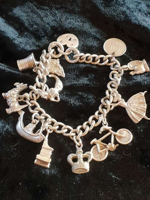 Stunning genuine silver charm bracelet with all charms