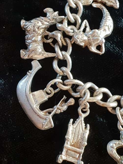Stunning genuine silver charm bracelet with all charms