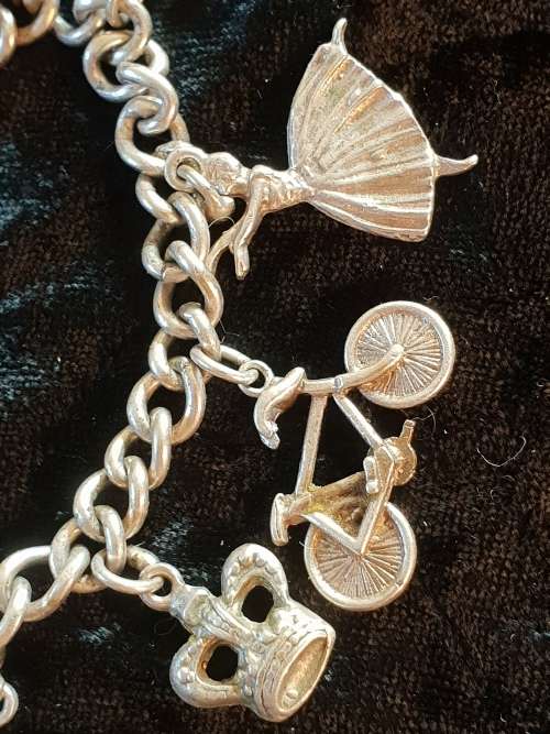 Stunning genuine silver charm bracelet with all charms