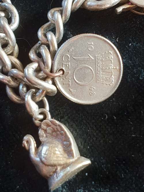 Stunning genuine silver charm bracelet with all charms