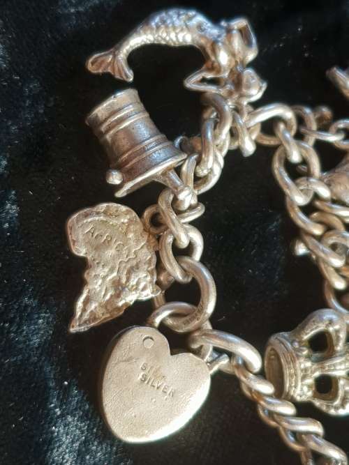 Stunning genuine silver charm bracelet with all charms