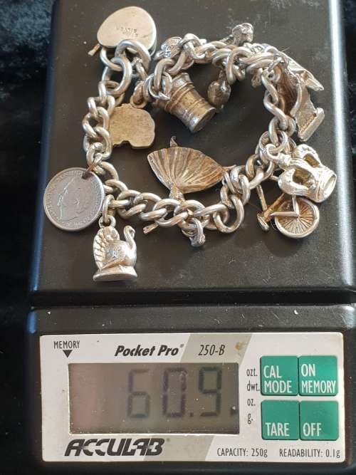Stunning genuine silver charm bracelet with all charms