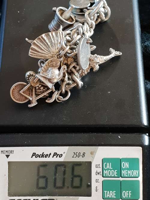 Stunning genuine silver charm bracelet with all charms