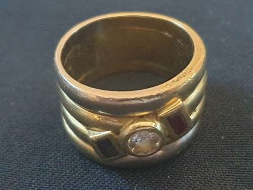 18ct 1/2 carat diamond with .20 carat ruby and .20 carat sapphire broad ring