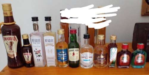 23 miniature sealed alcohol bottles