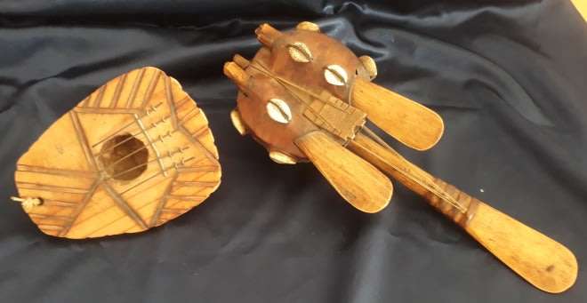 A Handcrafted African Thumb Piano and String Instrument Decorated with Cowrie Shells