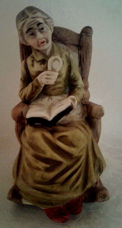 Two ornaments of and old couple on rocking chairs - lovely Pair.