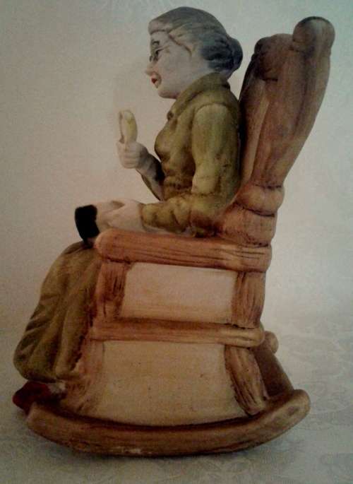 Two ornaments of and old couple on rocking chairs - lovely Pair.