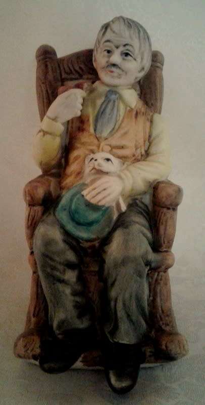 Two ornaments of and old couple on rocking chairs - lovely Pair.